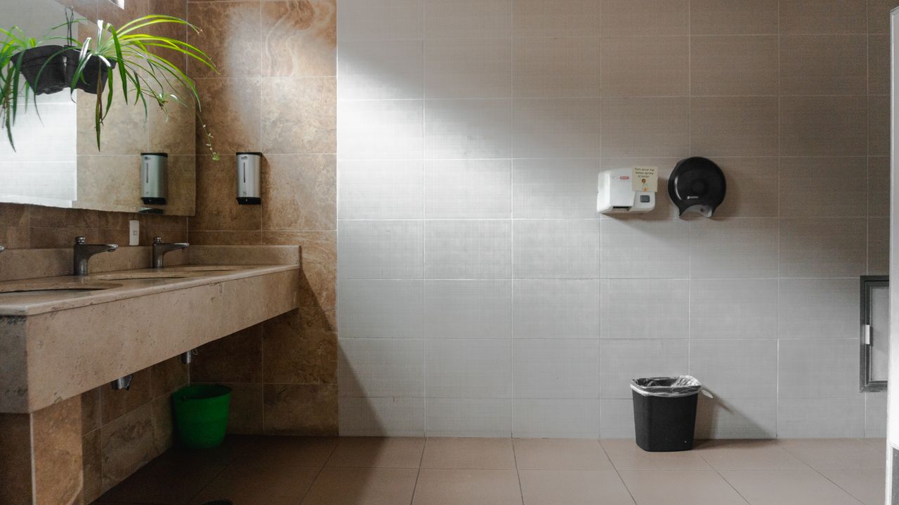 Clean and spacious public bathroom with sinks and hand dryer, Mexico.